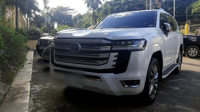Stock photograph of a white SUV on a forecourt