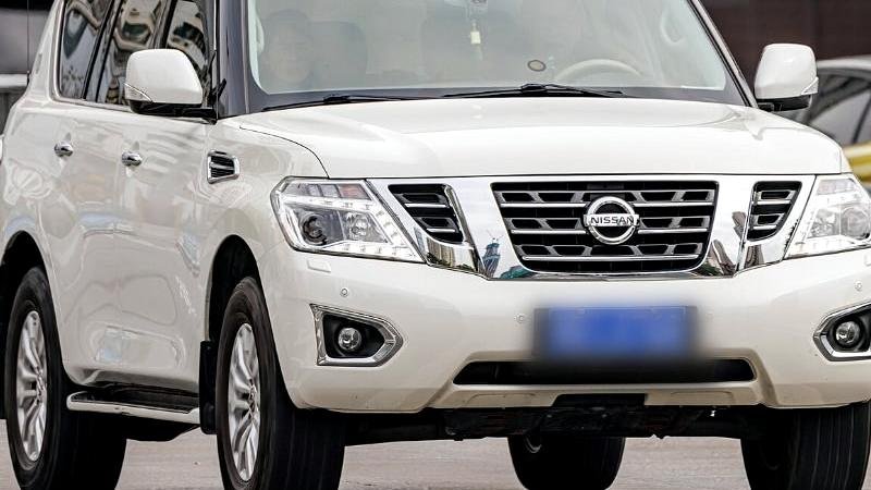 Stock photograph of a large SUV on a forecourt