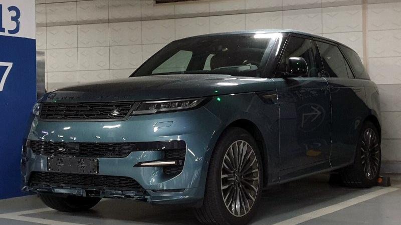 Stock photograph of an SUV parked outside a showroom