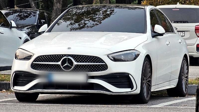Stock photograph of a white saloon car